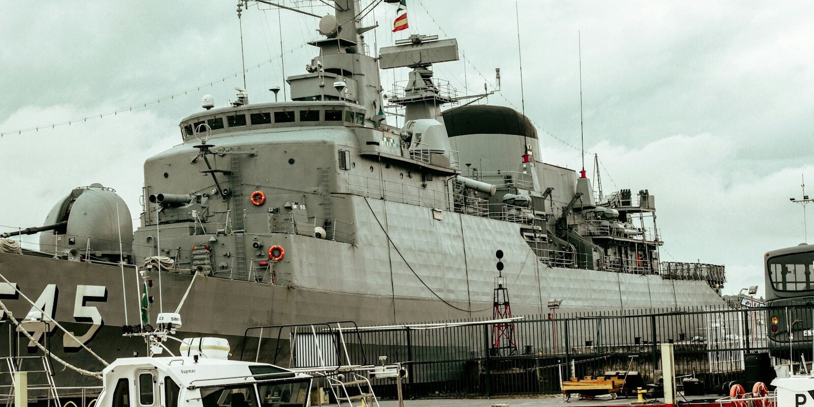 a large gray ship docked in a harbor